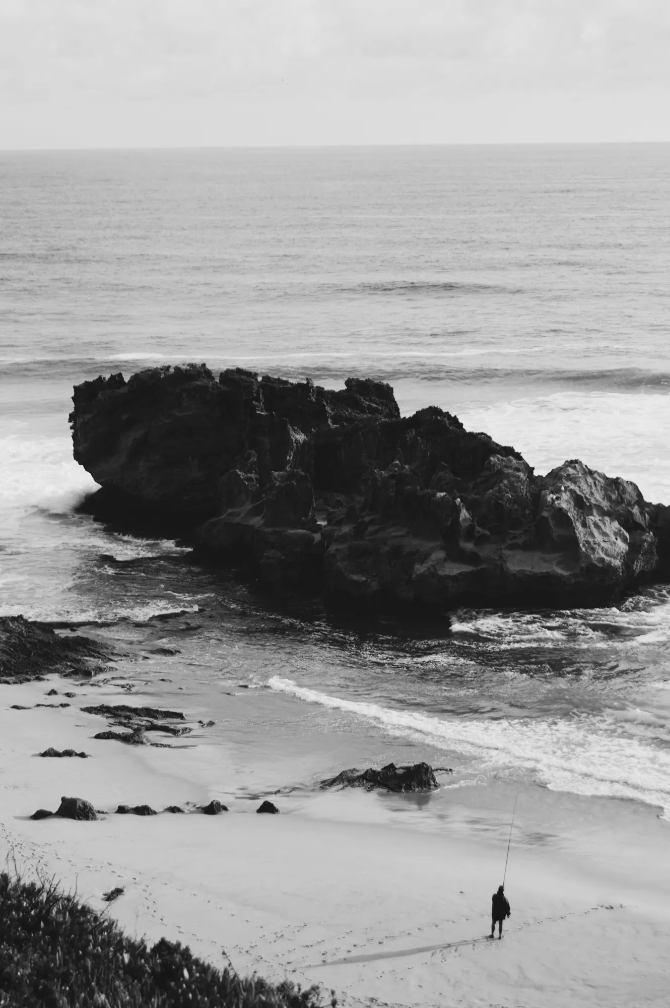 2019-12-24 - Knysna - Person on beach next to a giant rock