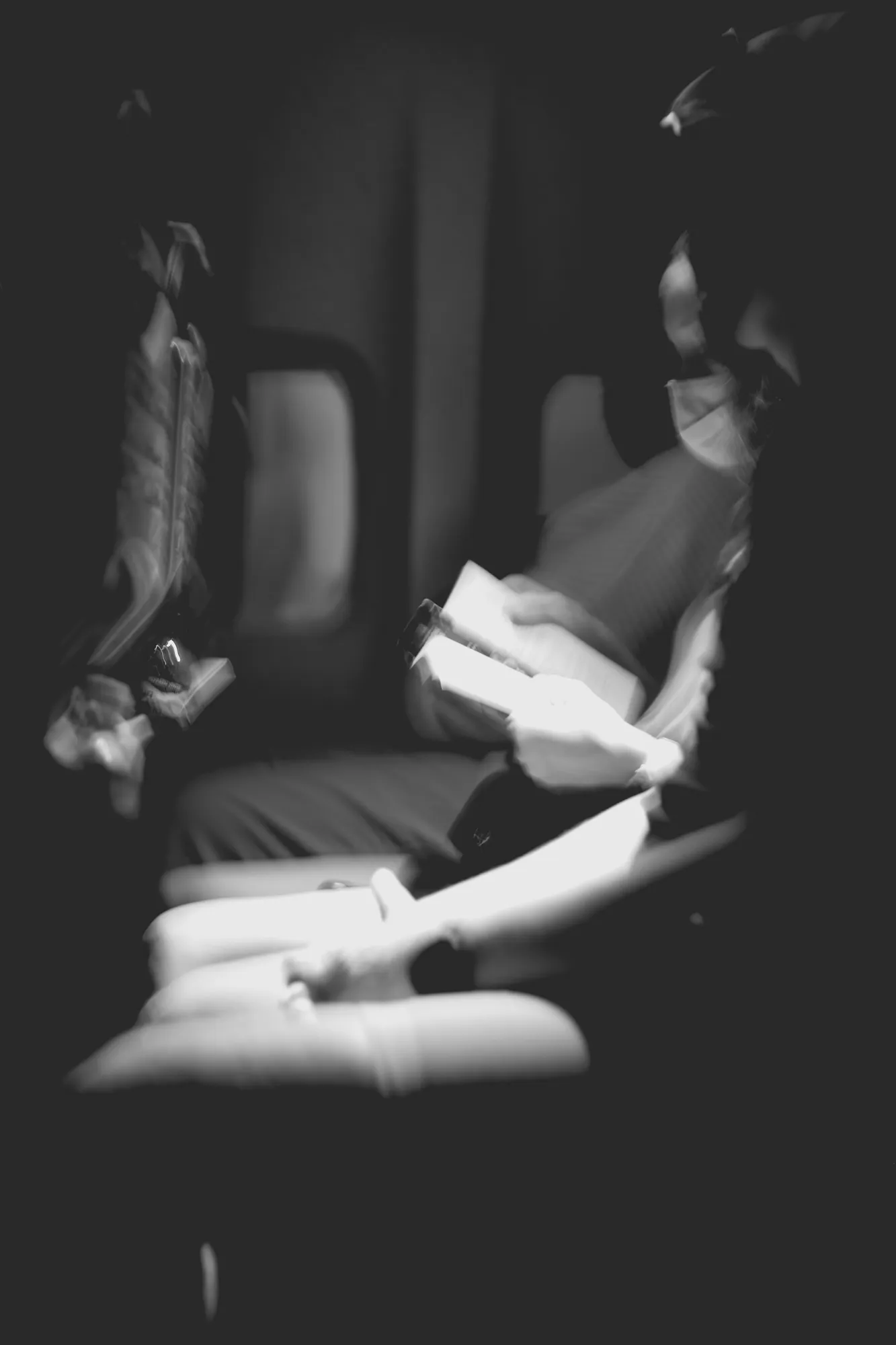2022-02-18 - Cape Town - Person reads book in the dark on airplane