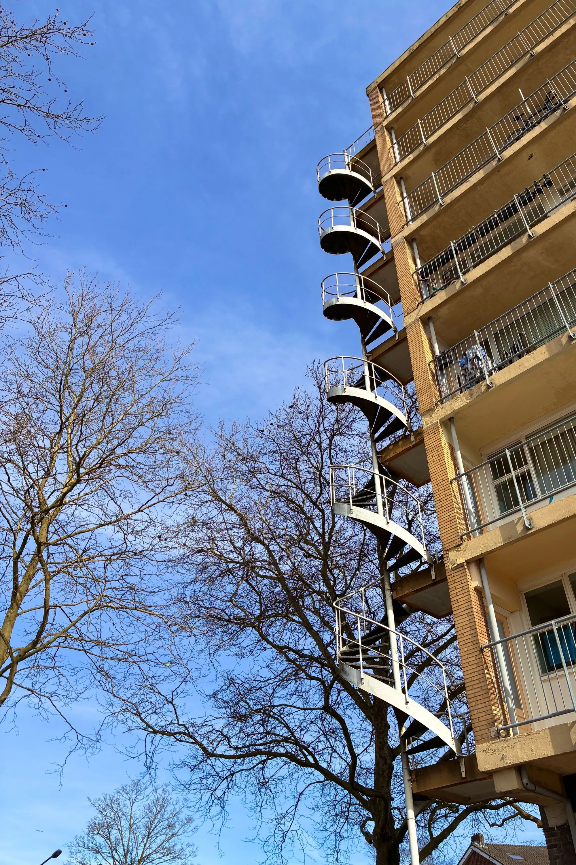 2026-03-20 - Spiral staircase on side of appartment building
