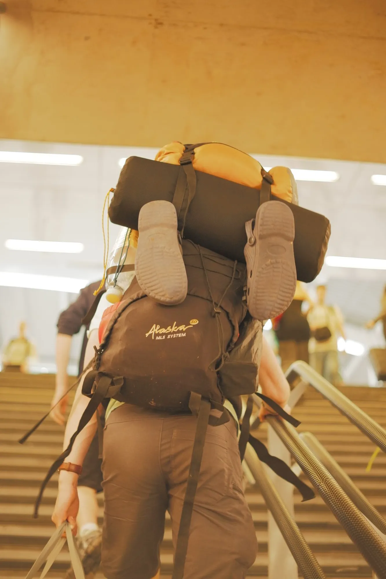 2026-05-31 - Hiker walking up escalator