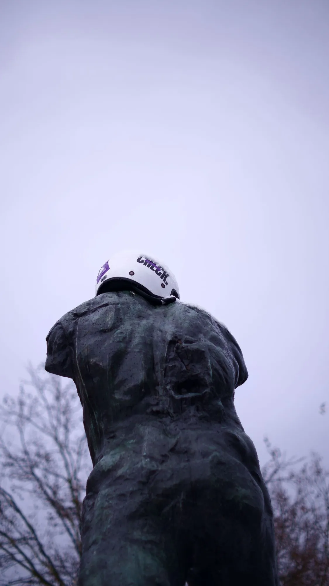 Bike helmet on an armless statue