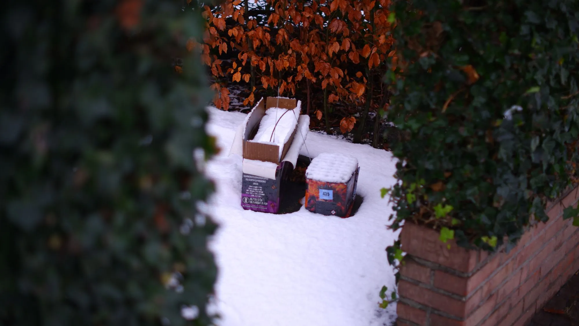 Boxes of fireworks sitting out in the snow