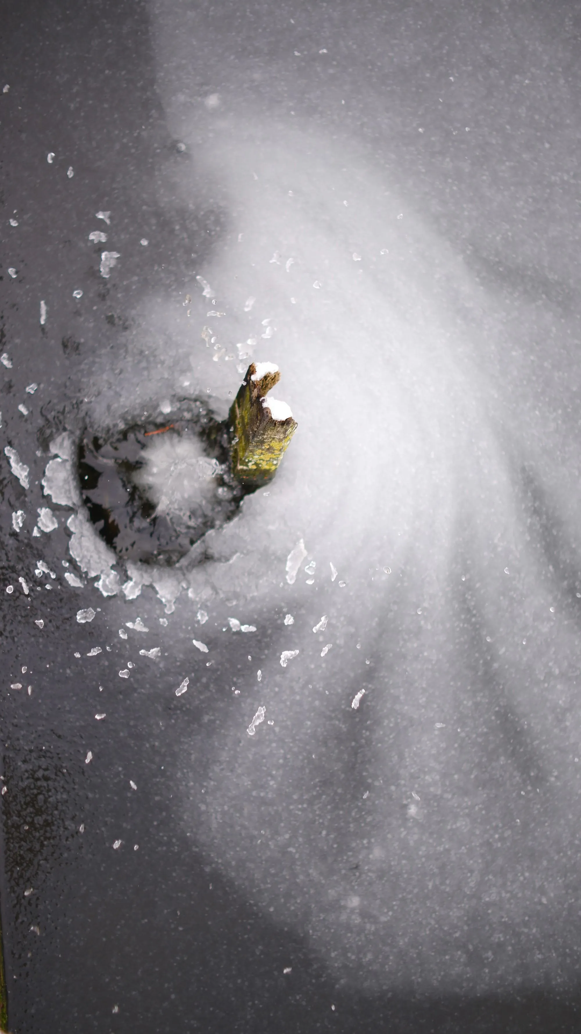 Ice spattering on frozen lake