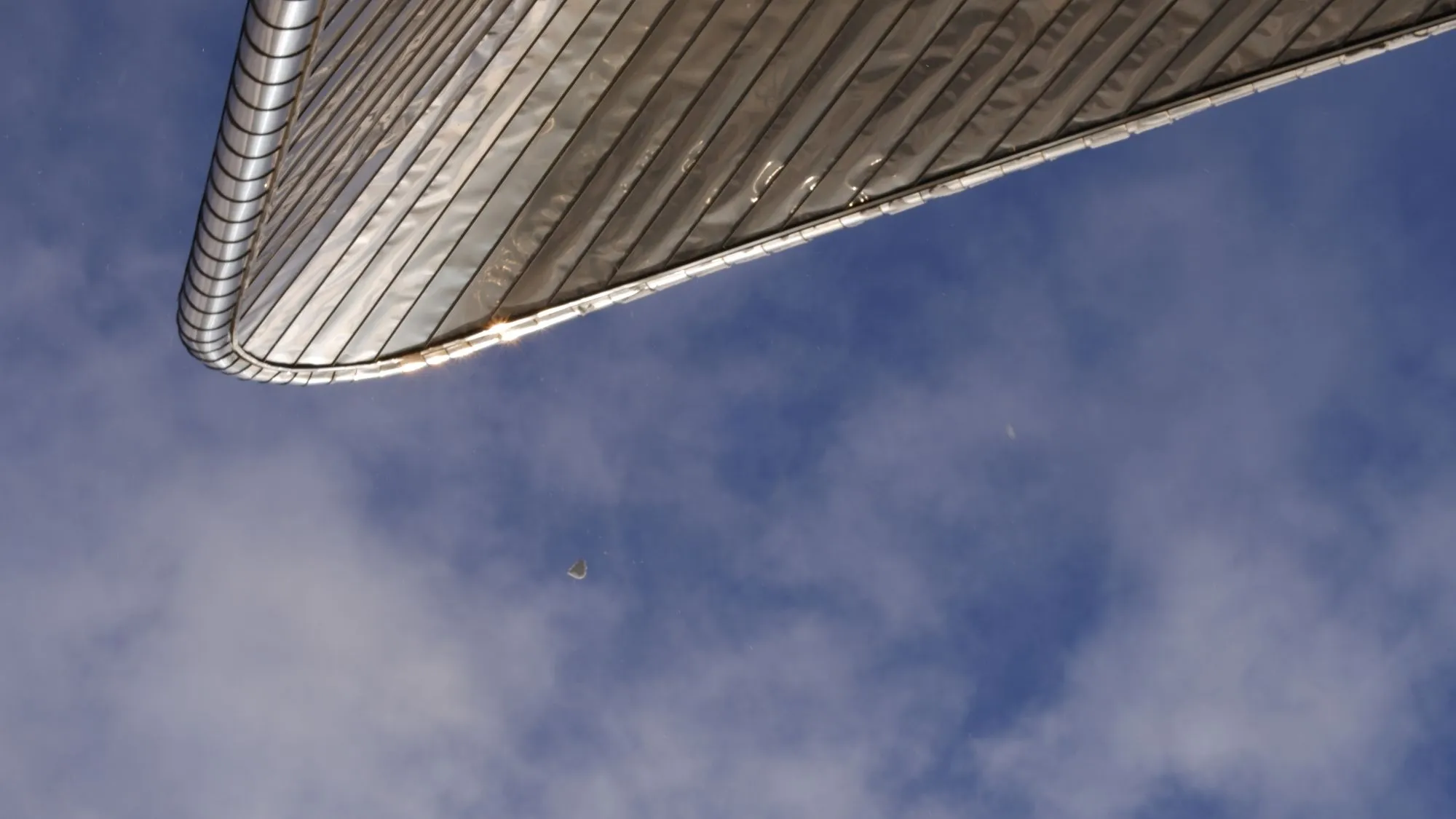 Roof of train station with a clump of snow falling down