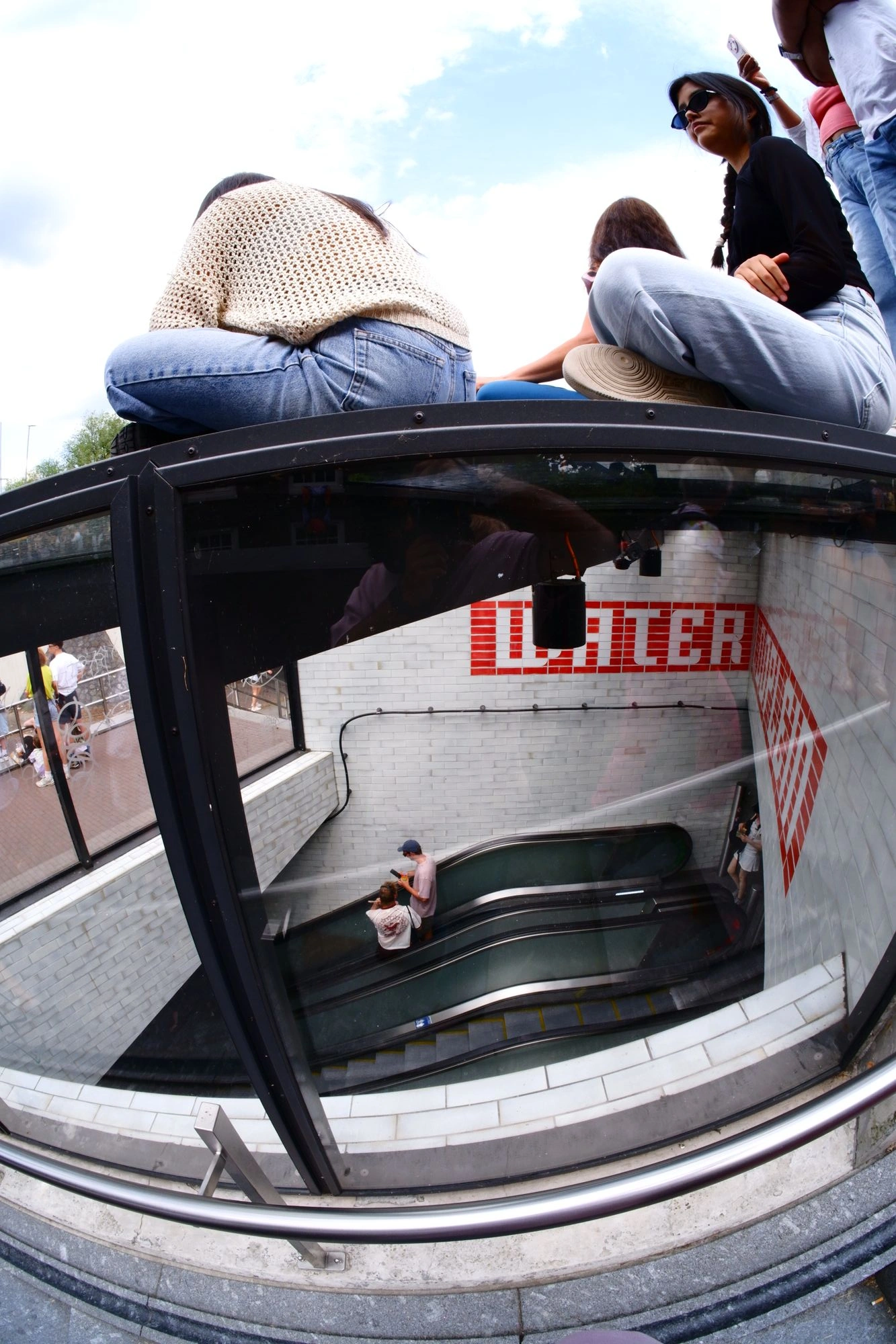 2026-08-01 - xt7.5 - color - NL - Amsterdam - People sitting on top of subway enterance