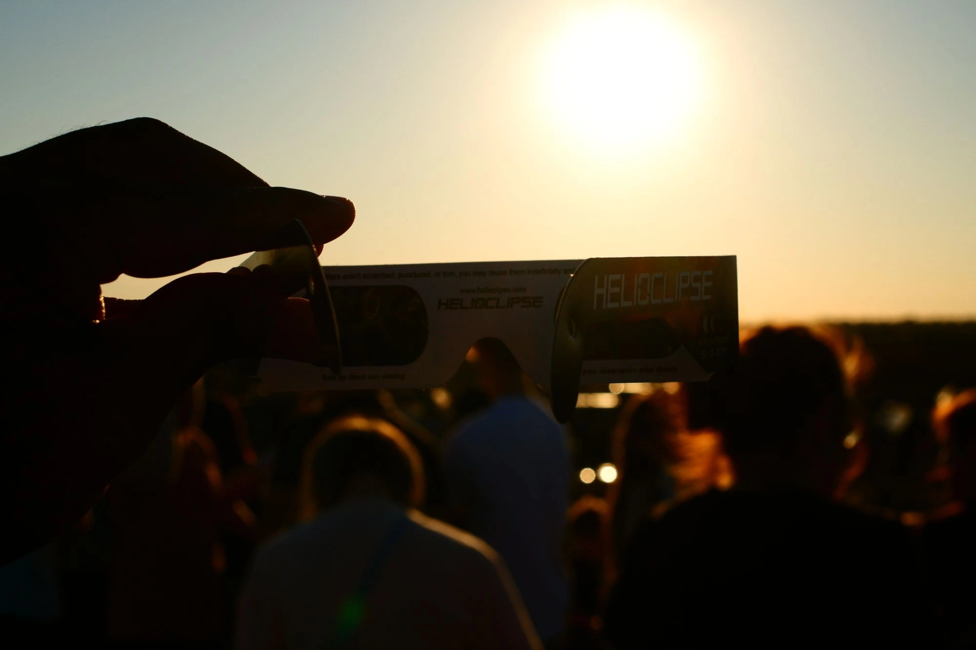 Eclipse glasses with sun in background