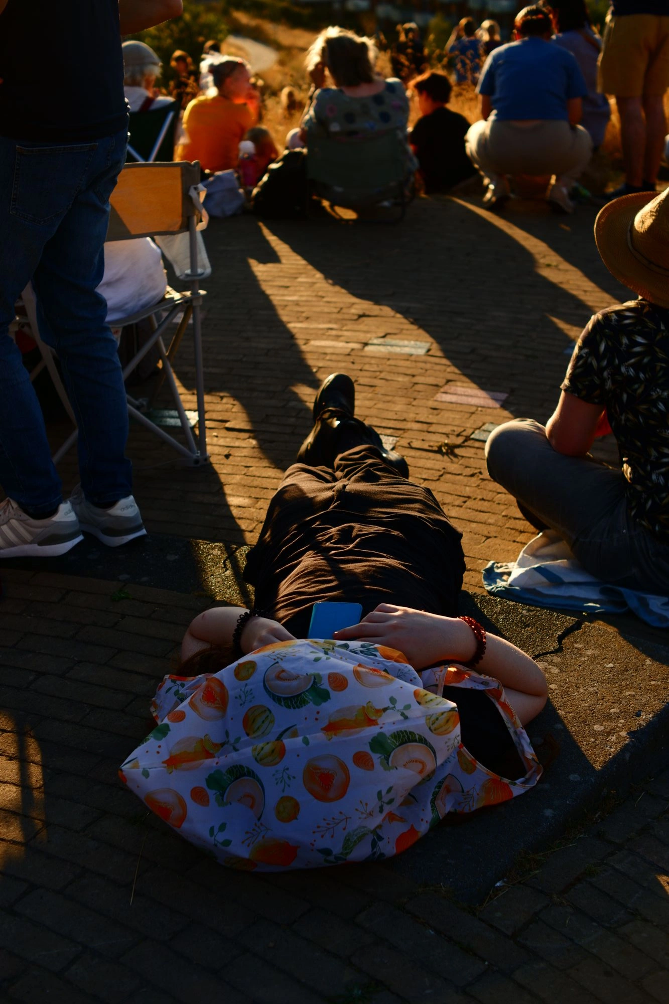 Person laying on ground with bag over head