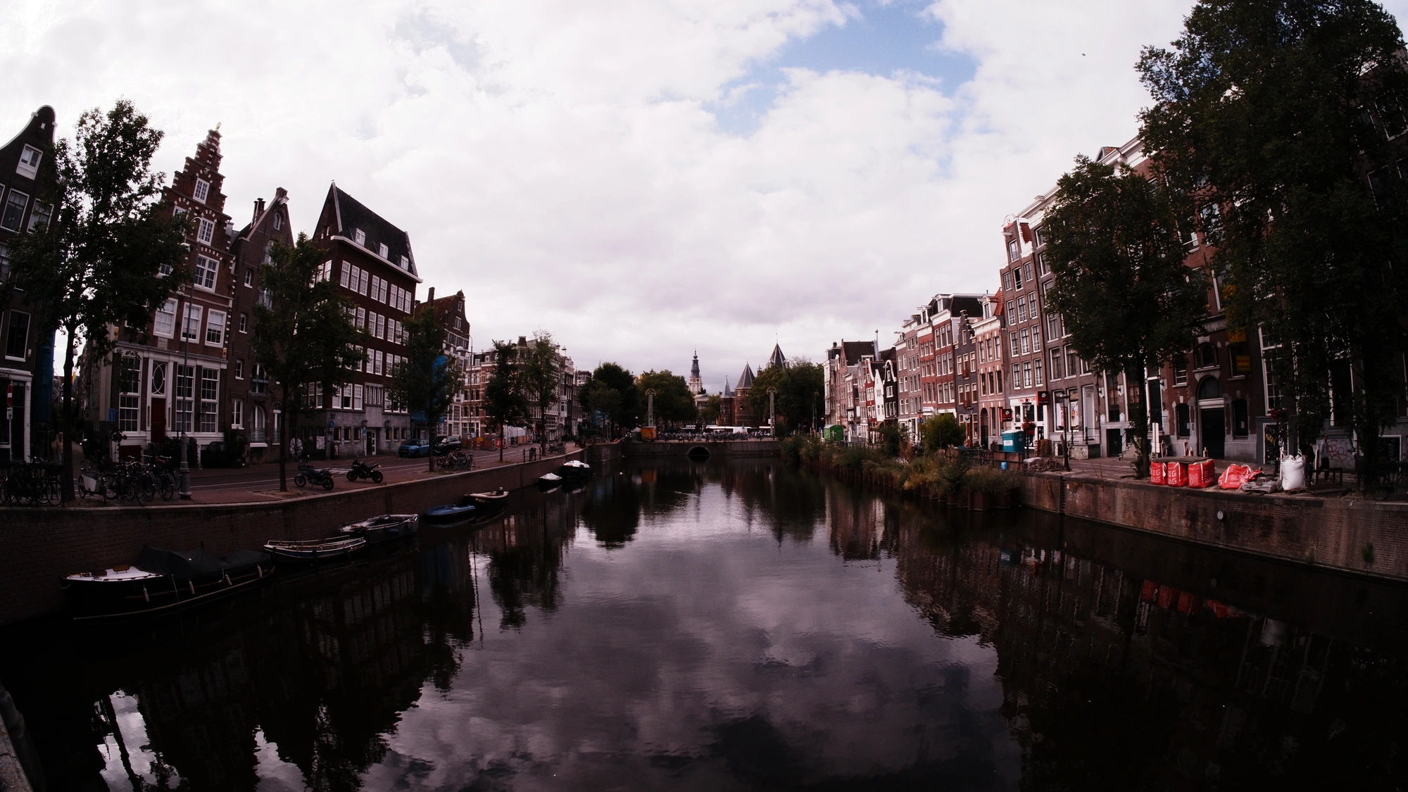 Large canal lined by buildings reflected in the water