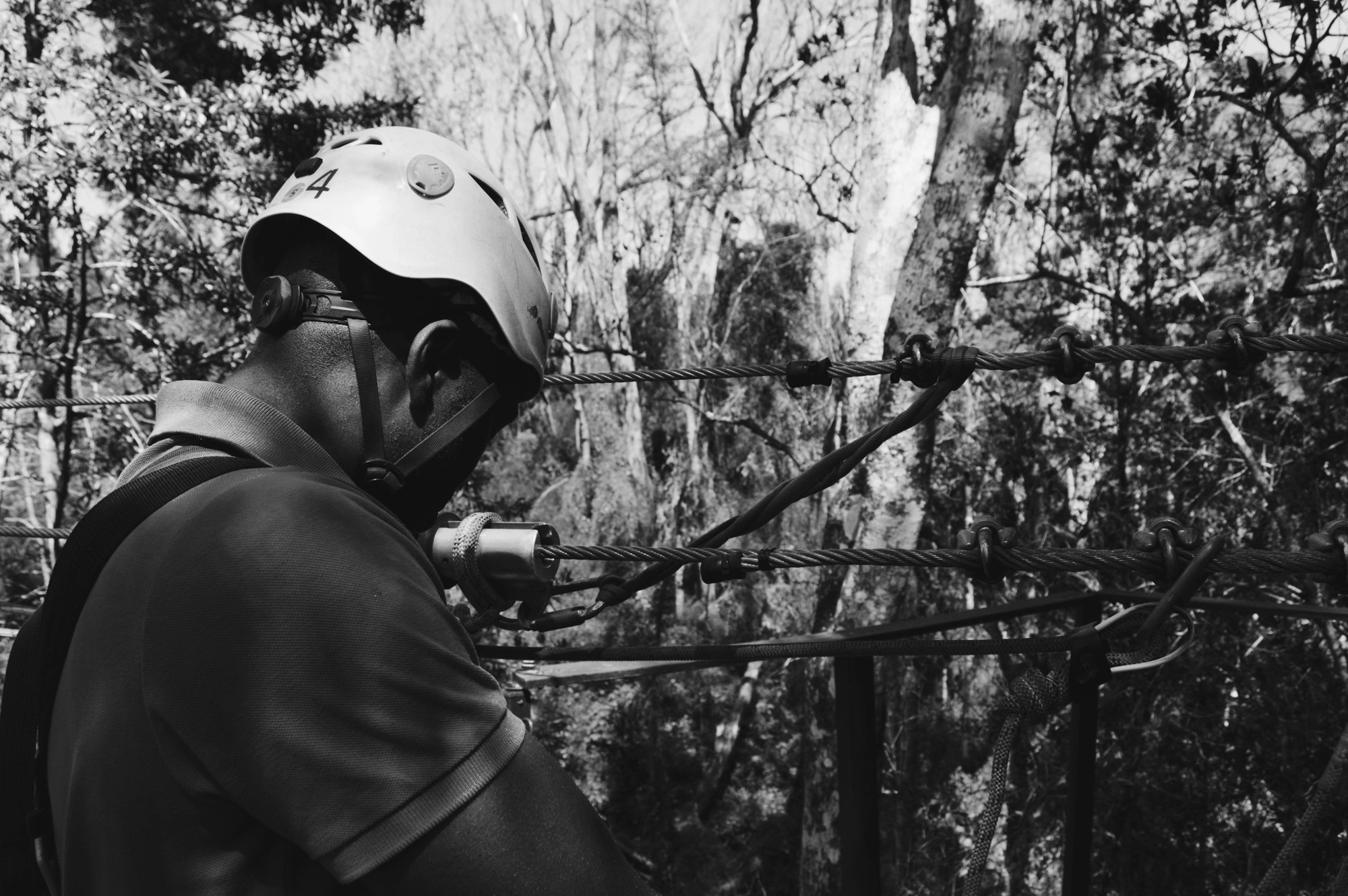 Peroson with climbing gear fixes harness