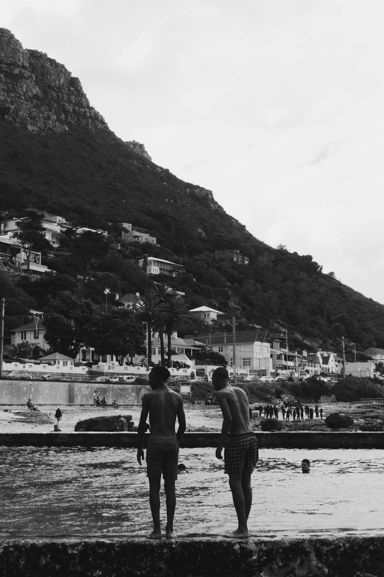 Boys standing at the edge of the water