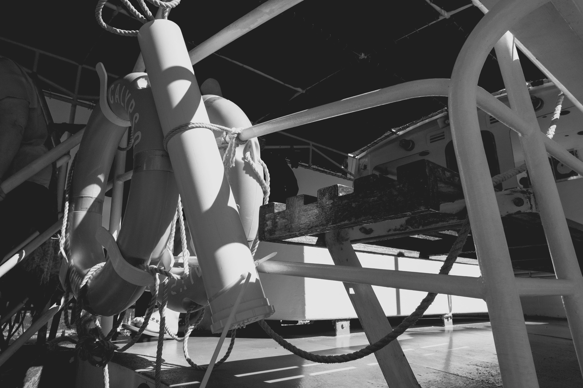 2022-02-13 - xt15-45 - bw - ZA - Cape Town - Floatation devices hung on a boat