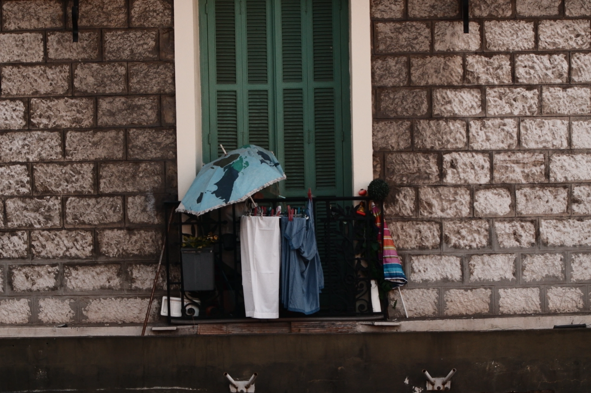 Laundry and imbrellas on balcony