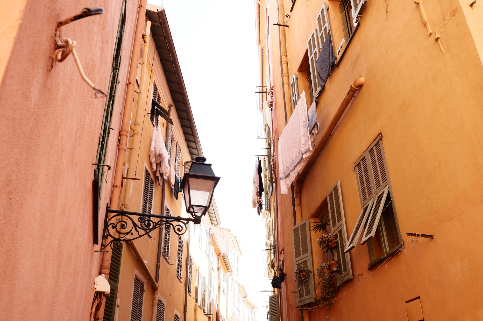 Washing hanging on two buildings facing each other
