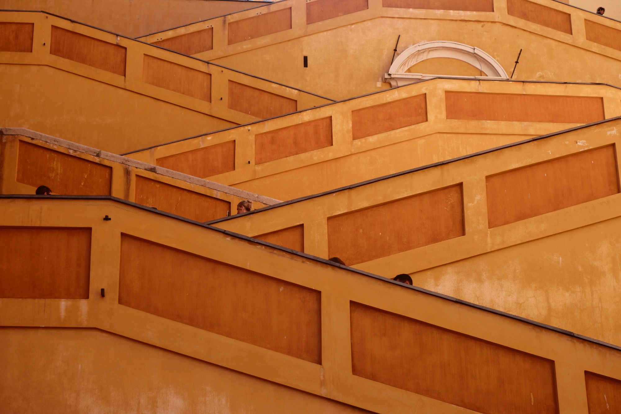 Many levels of staricases and orange walls