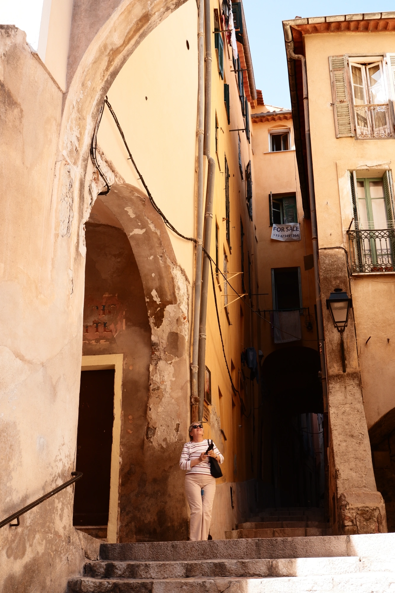 Person standing amongst small orange buildings