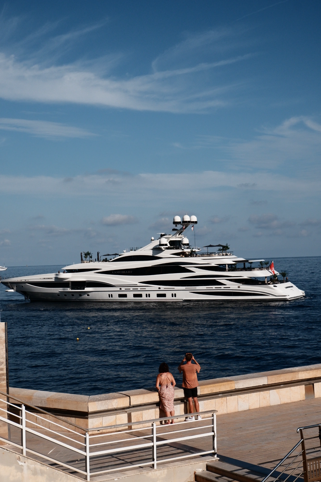 People loking at huge yacht