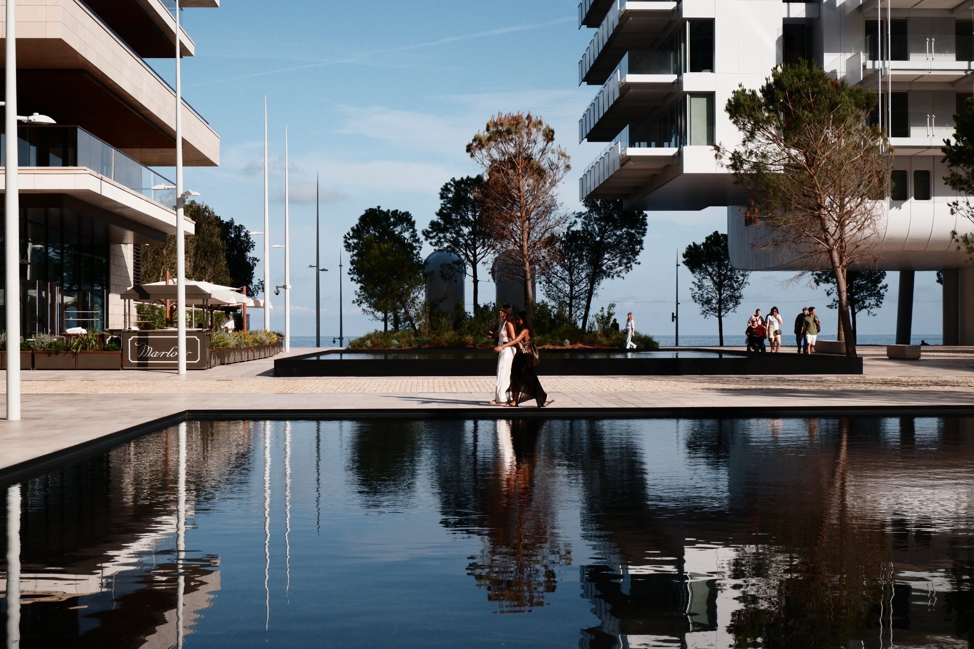 People walking next to pool