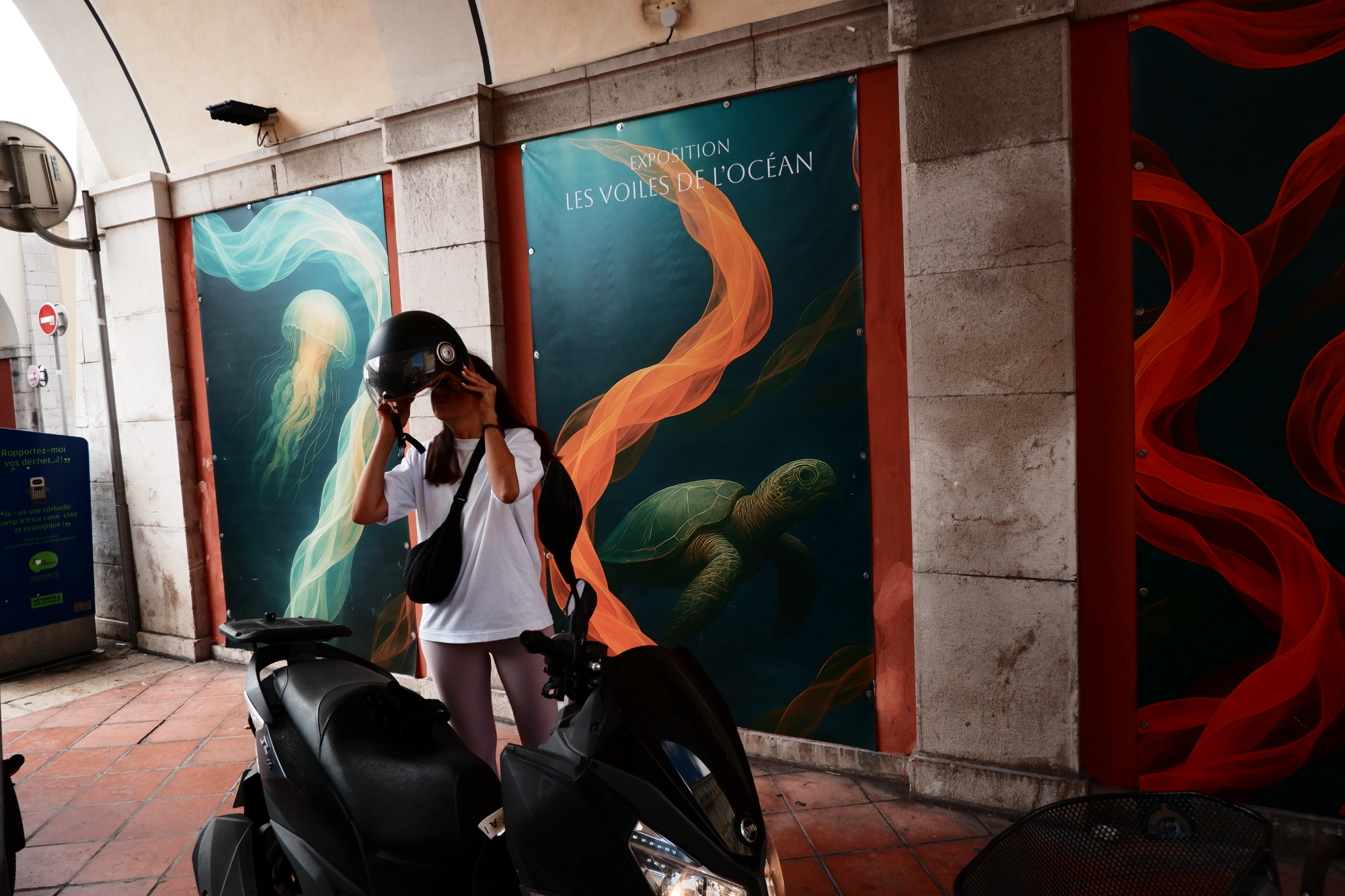 Person putting on scooter helmet