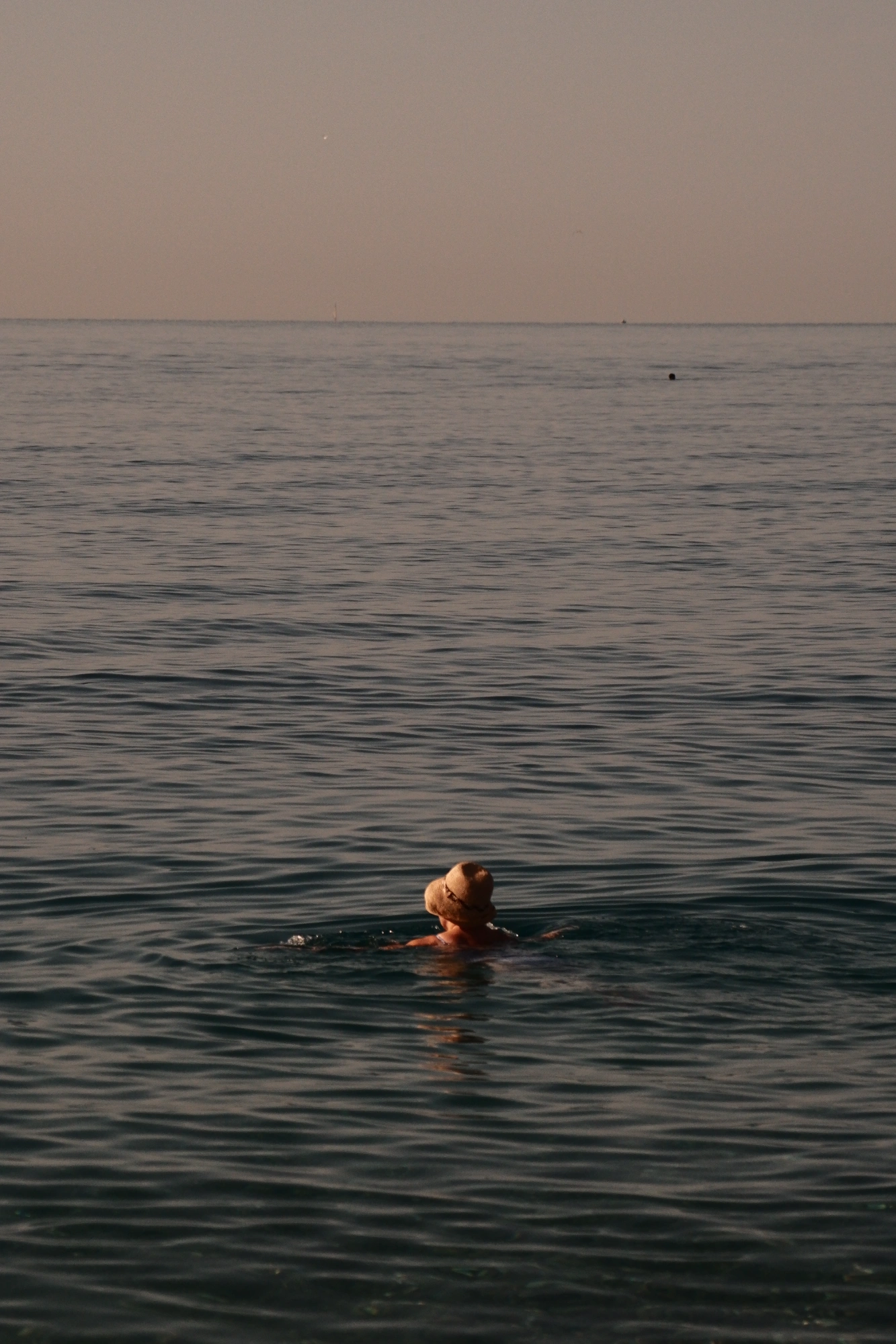 Person with hat in the water