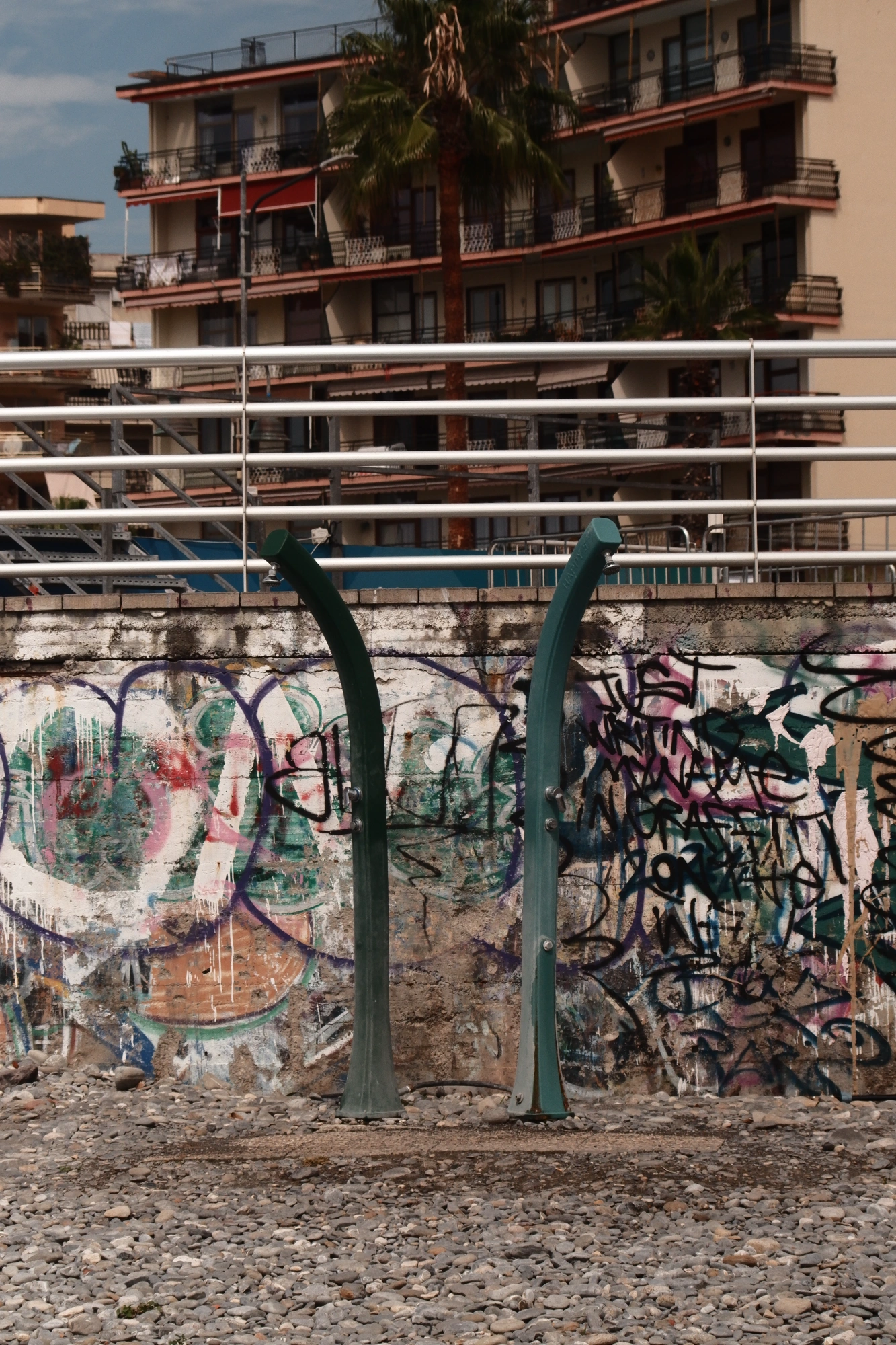 Showers on beach in front of graffiti