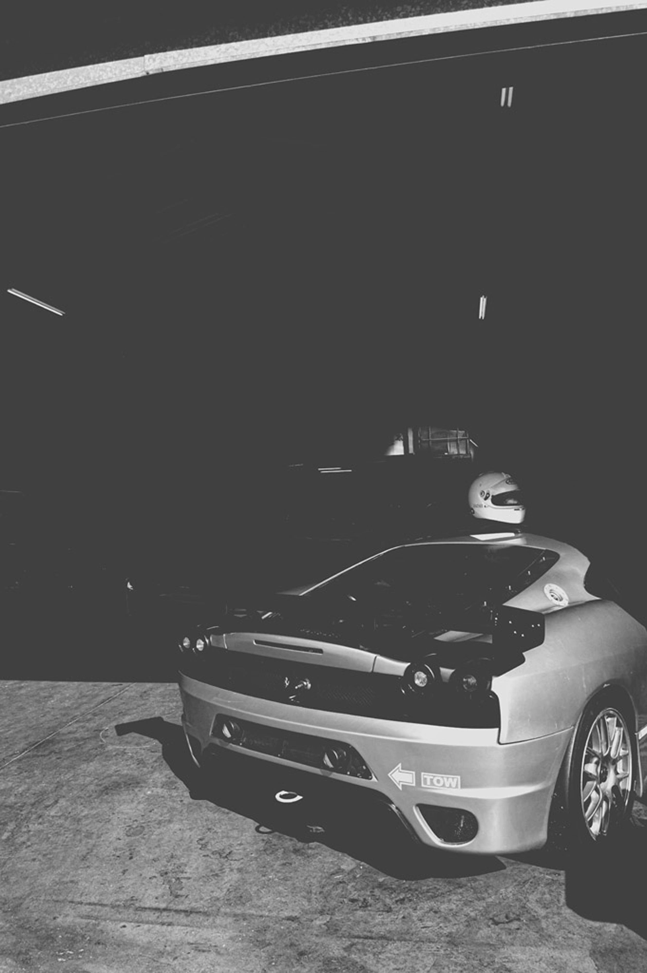 2019-07-27 - n18-55 - bw - ZA - Zwartkops Raceway - Back of Ferarri in garage