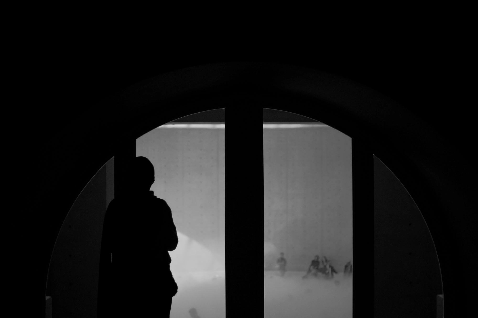 2026-07-06 - Summer in Paris - Person standing in front of window in shadow.j