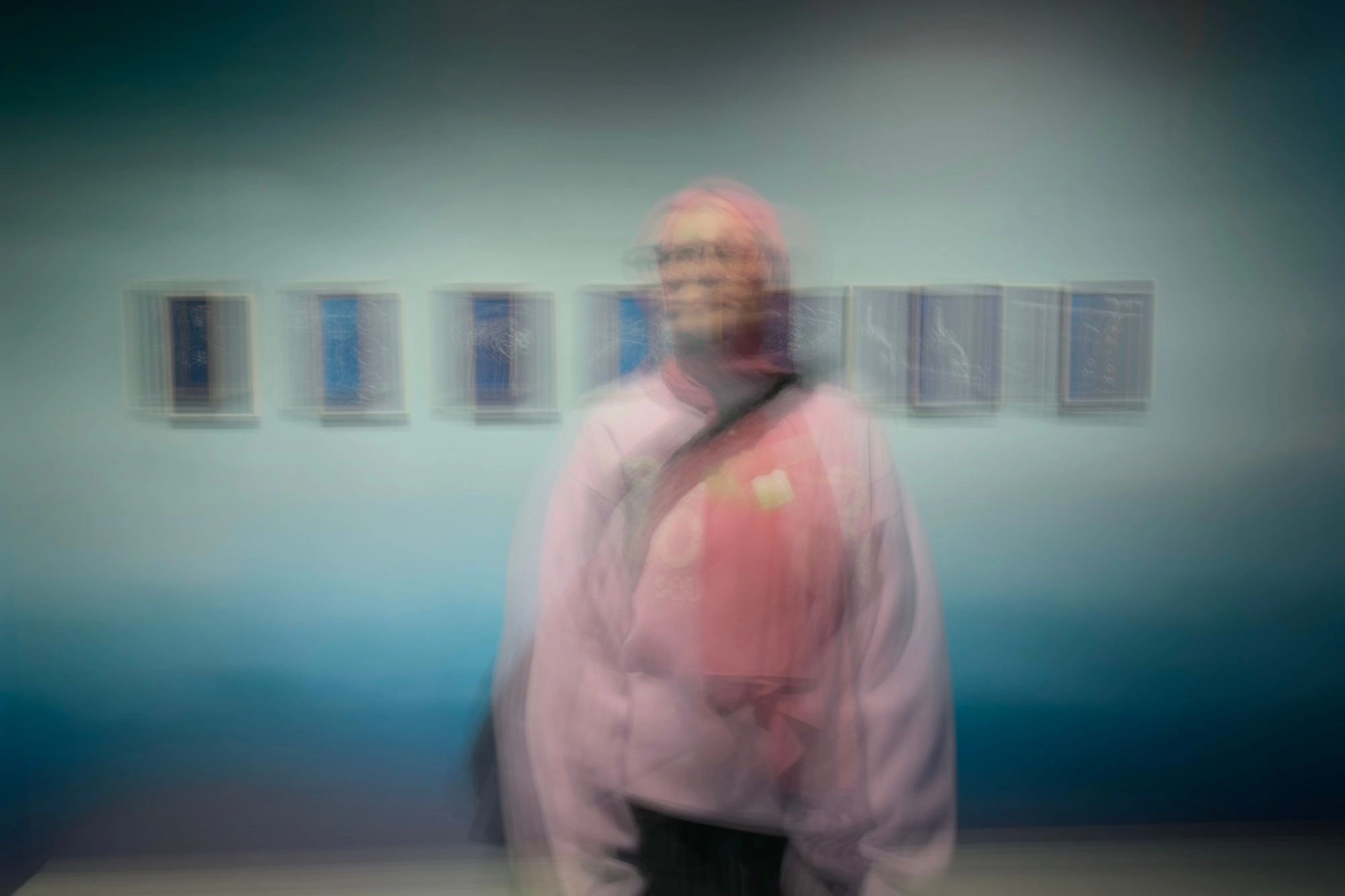 2026-03-28 - Blurry person in front of all of cyanotype prints.J
