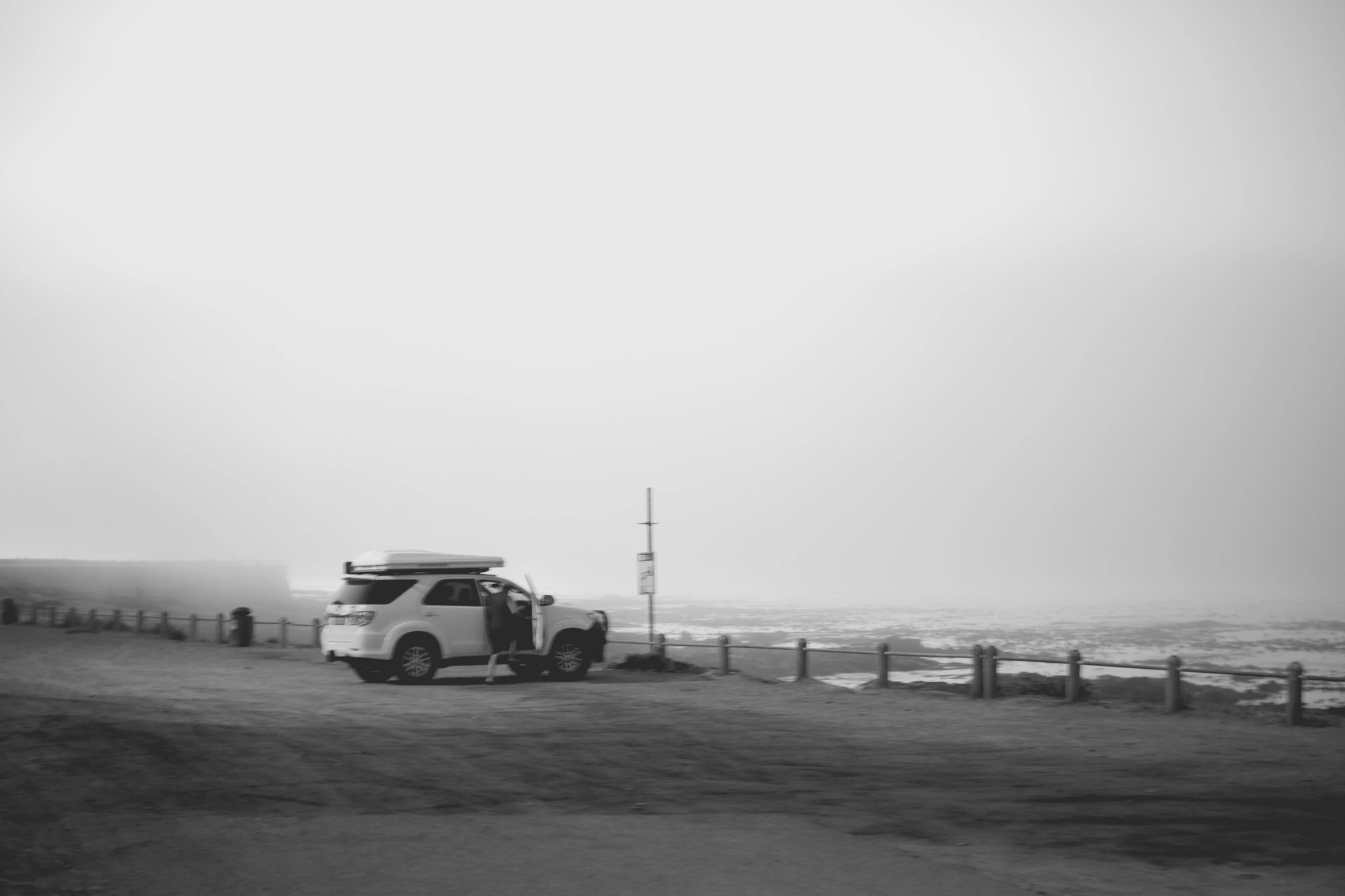 2022-02-15 - Cape Town - Car parked beside beach on misty day.j