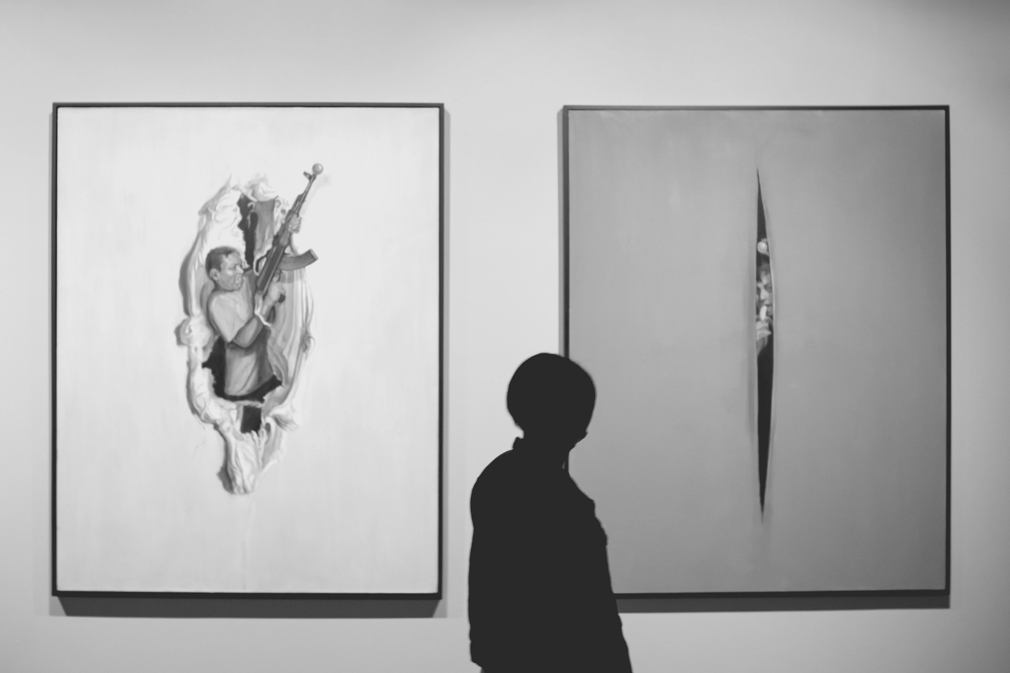 2022-02-16 - Cape Town - Shadow of person standing between two paintings.j