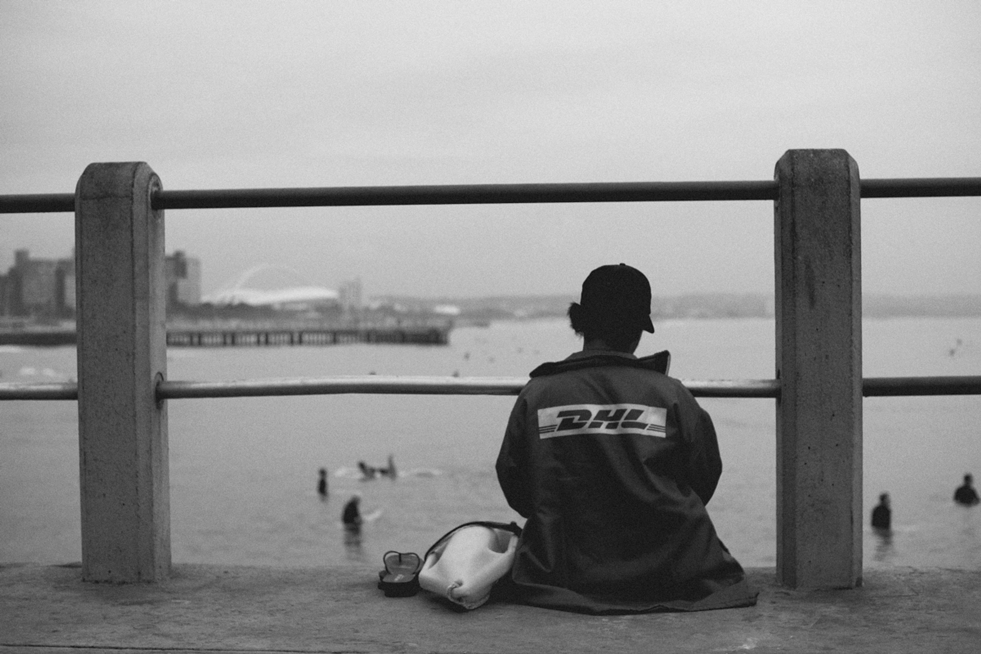 2022-09-18 - Durban -  Lifeguard sitting on edge of pier.j