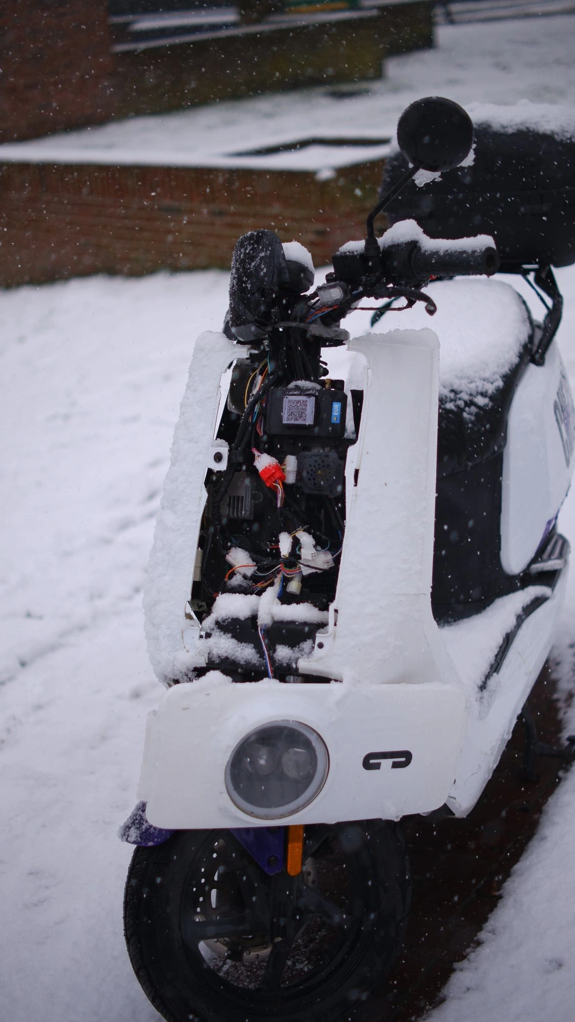 Broken scooter in the snow.J