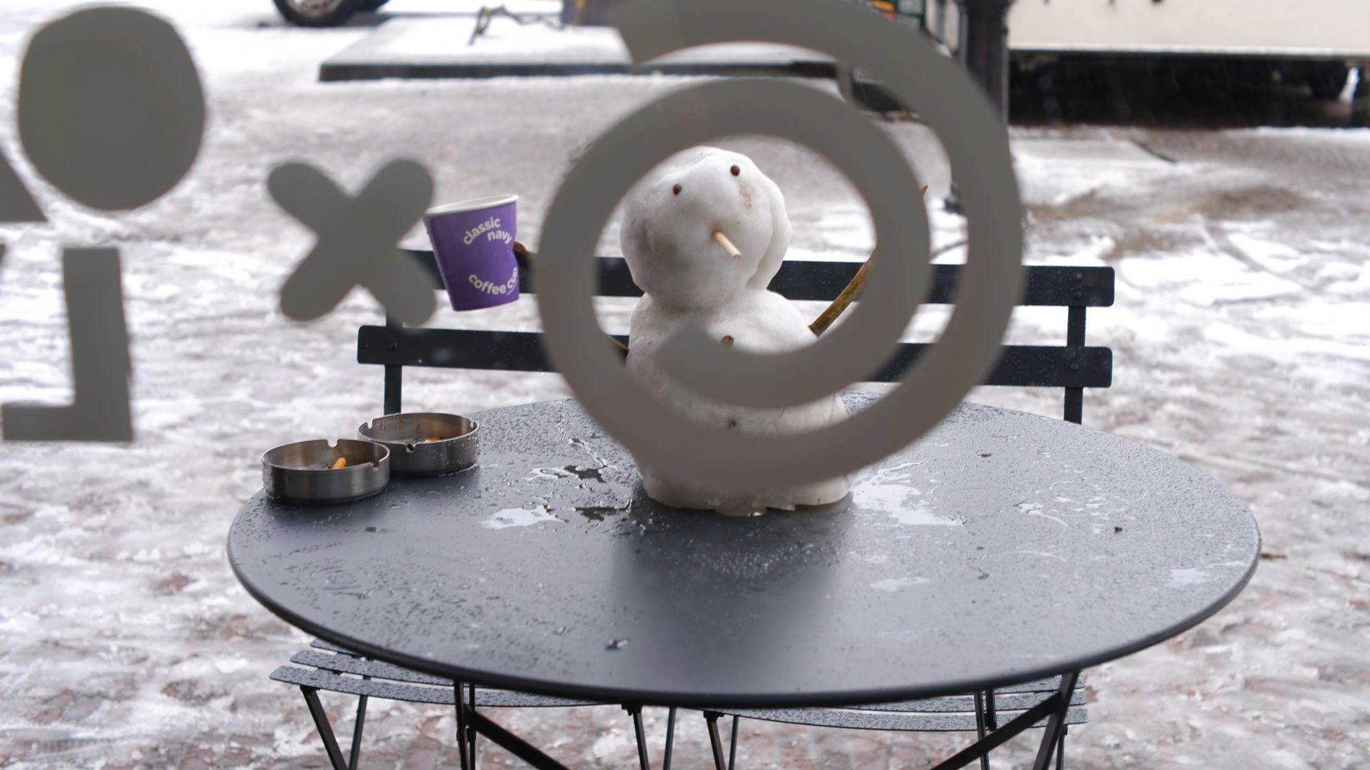 Snowman through circle on window.J