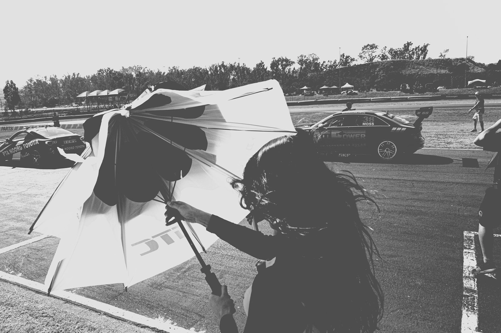 2019-07-27 - Zwartkops Raceway - Person with umbrella walks across track.j